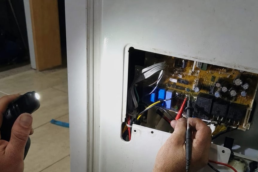 Appliance control board with a meter probe on one of its terminals
